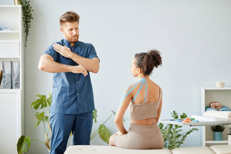 Ongoing physiotherapy session improving shoulder mobility and posture - One Body LDN Ongoing physiotherapy session improving shoulder mobility and posture