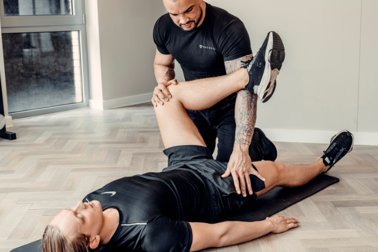 Physiotherapist gently guiding patient through specialist rehab stretch