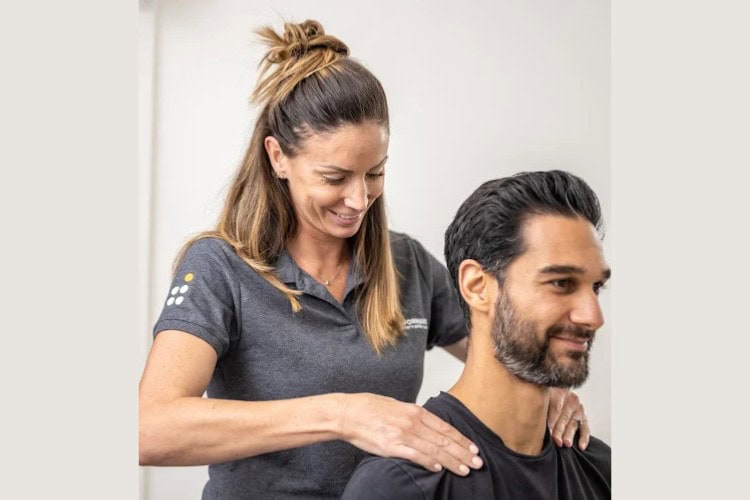 Pro Performance Clinics therapist treating male patients neck pain