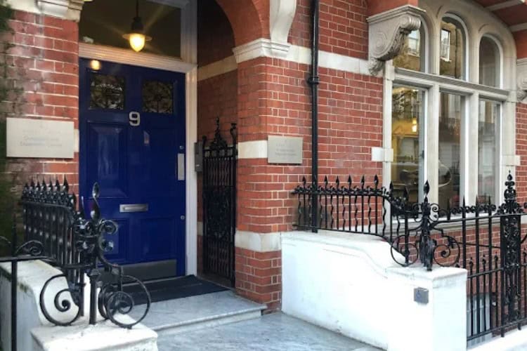 3 Exterior entrance of London Pain Clinic with blue door and signage - One Body LDN Exterior entrance of London Pain Clinic with blue door and signage
