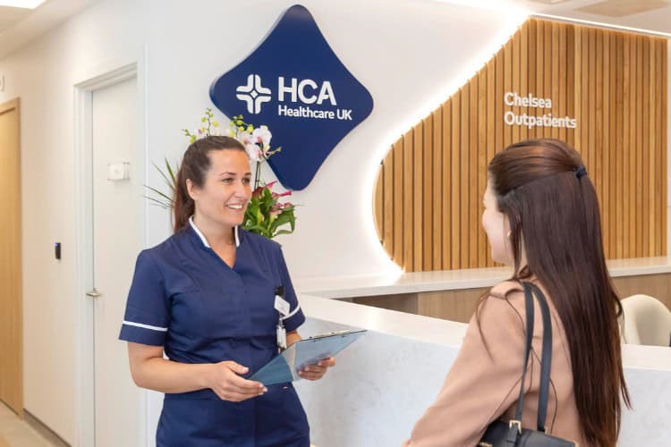 Receptionist assisting patient at HCA Healthcare UK clinic London