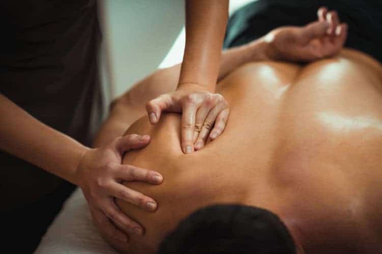 Therapist performing deep shoulder massage at Third Space Spa