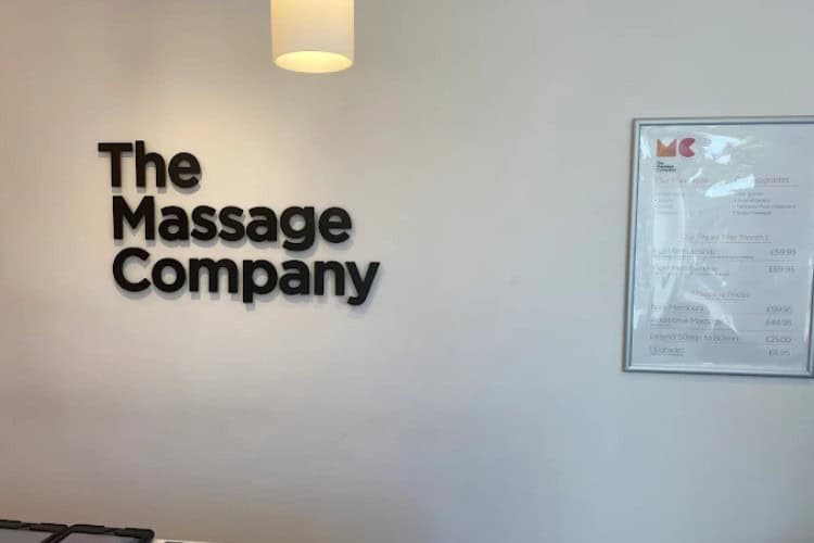 Reception wall signage at The Massage Company Harrow clinic
