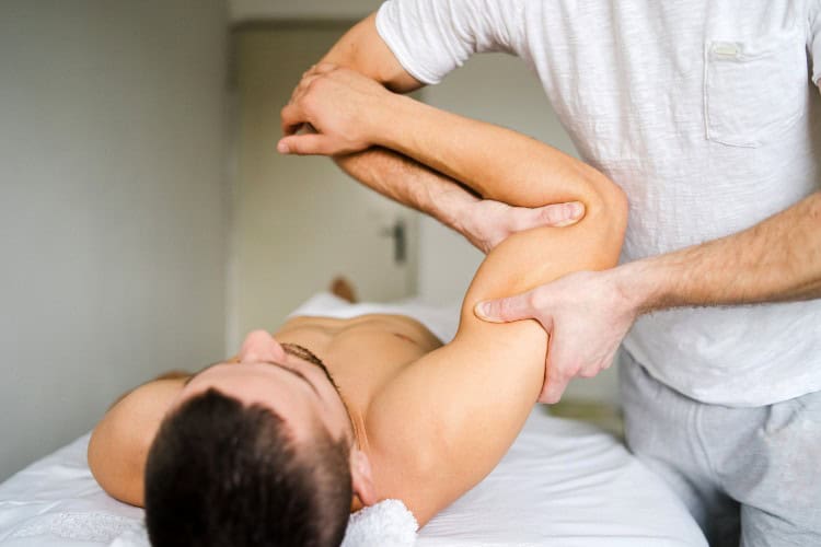 7 Male patient receiving manual arm therapy at London Hand Clinic - One Body LDN Male patient receiving manual arm therapy at London Hand Clinic
