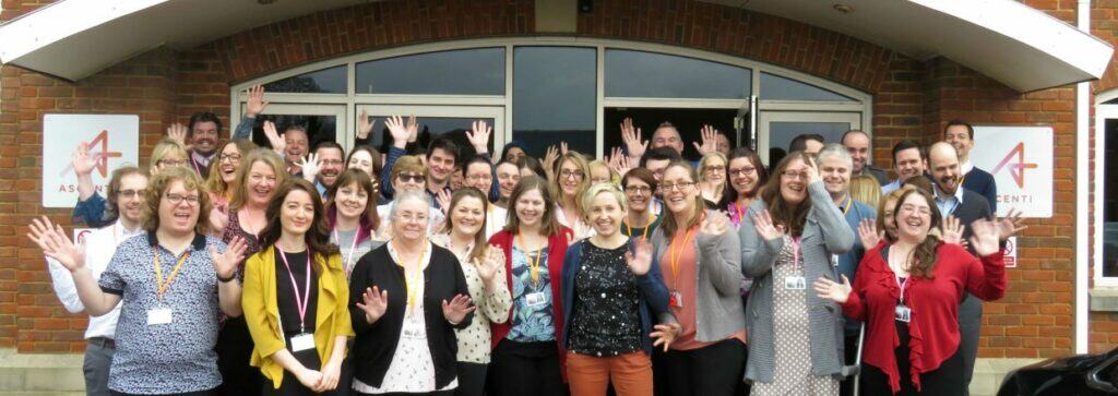 9 Ascenti healthcare team smiling and waving outside clinic entrance - One Body LDN Ascenti healthcare team smiling and waving outside clinic entrance