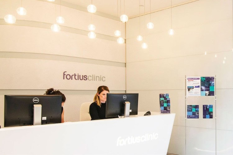 Receptionists working at modern Fortius Clinic front desk