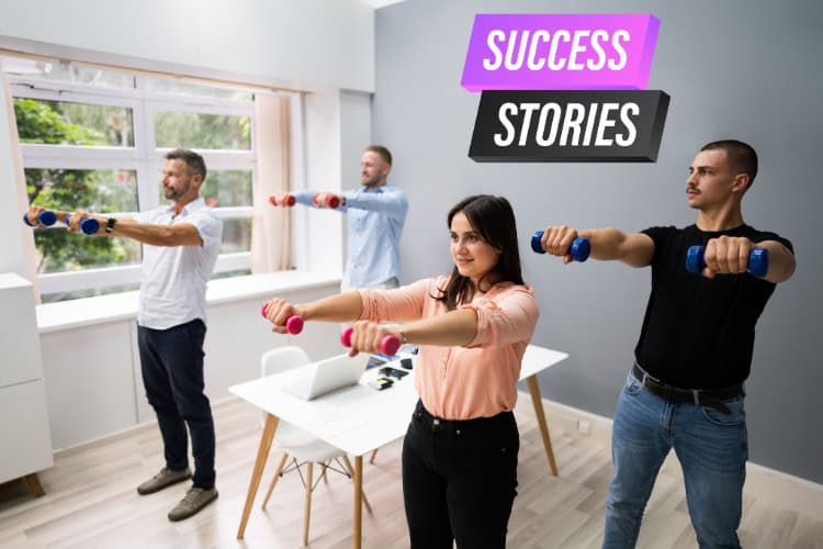 Corporate team doing desk workouts with physio support - One Body LDN Corporate team doing desk workouts with physio support