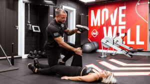 Male professional assisting a woman with knee pain