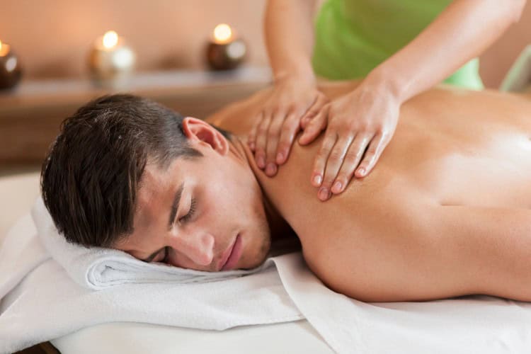 Man enjoying relaxing sports massage at London wellness clinic - One Body LDN Man enjoying relaxing sports massage at London wellness clinic