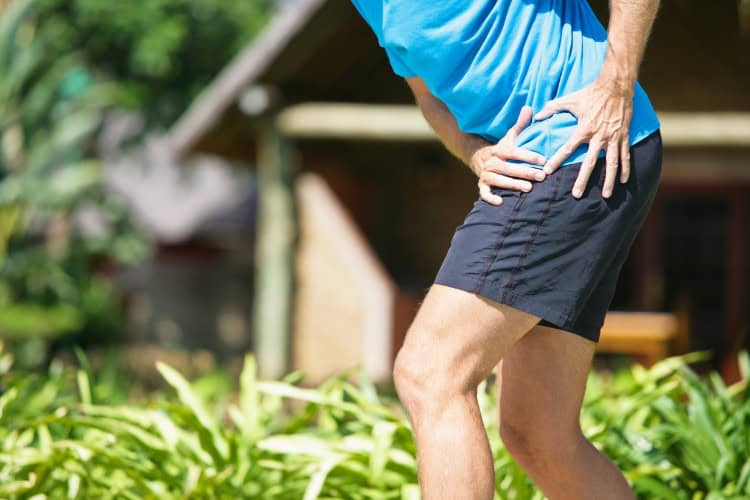 Man experiencing hip pain due to lack of proper rehab - One Body LDN Man experiencing hip pain due to lack of proper rehab