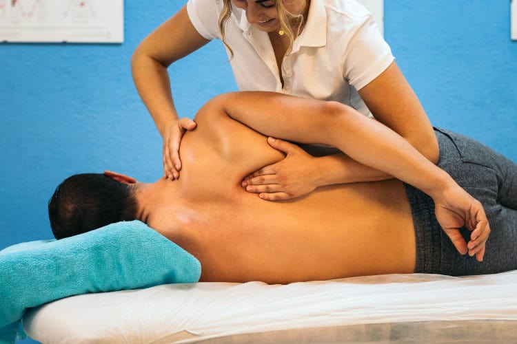 Manual therapy session showing back pain relief through hands-on care - One Body LDN Manual therapy session showing back pain relief through hands-on care