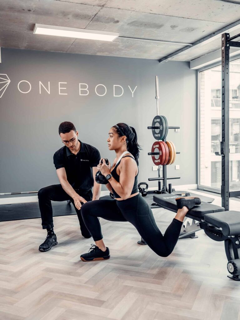 One Body LDN physio guiding strength rehab with dumbbell split squat