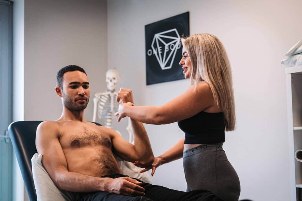 Osteopath treating male patient at One Body London clinic