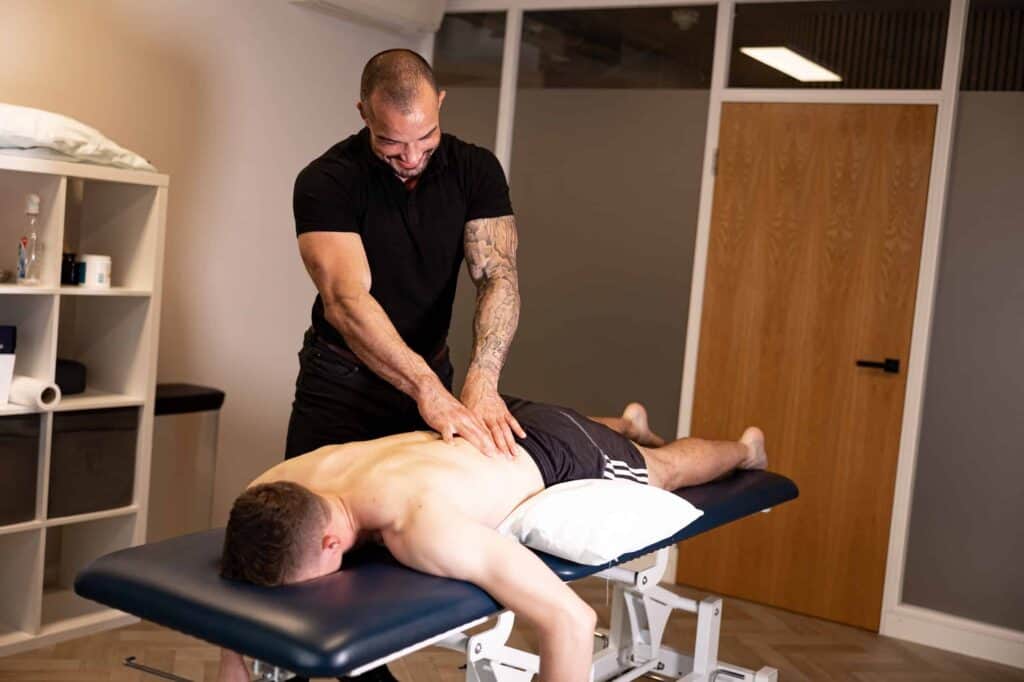 london physiotherapy massage for back pain - One Body LDN Physiotherapist performing deep tissue massage on patient’s back