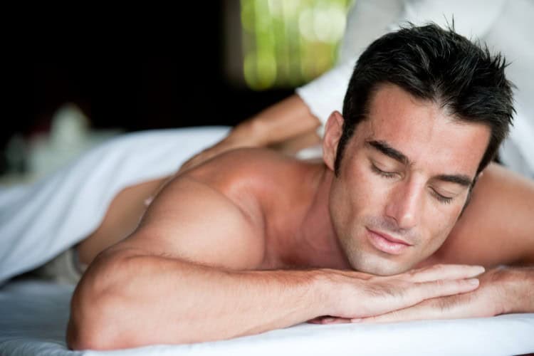 Relaxed male athlete receiving sports massage for peak performance