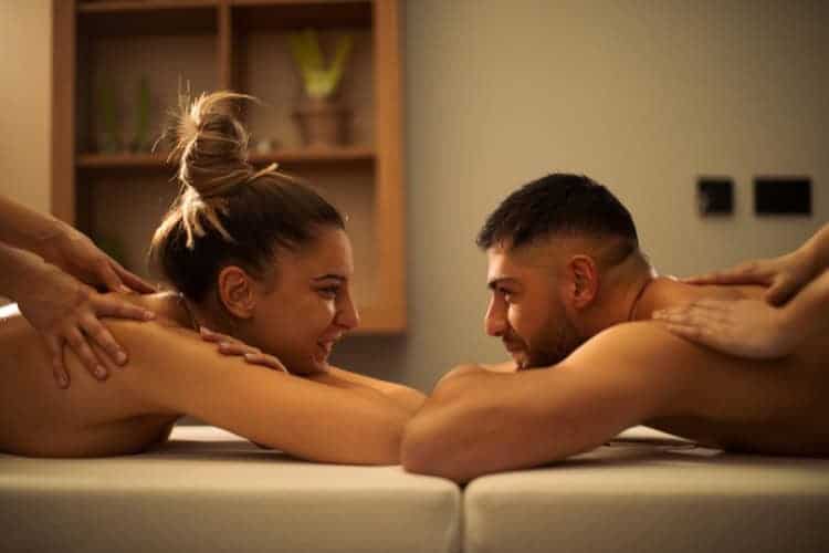 Smiling couple enjoying relaxing deep tissue massage together