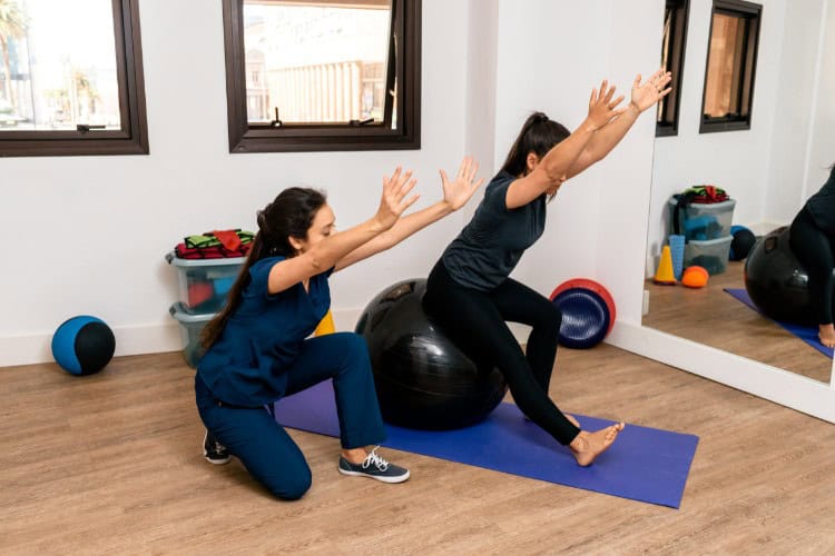 Why Expert Guidance Speeds and Secures Recovery - One Body LDN London physio guiding patient through balance exercise for recovery