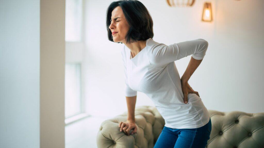 Woman with lower back pain needing physio-recommended exercises London Physiotherapy in London