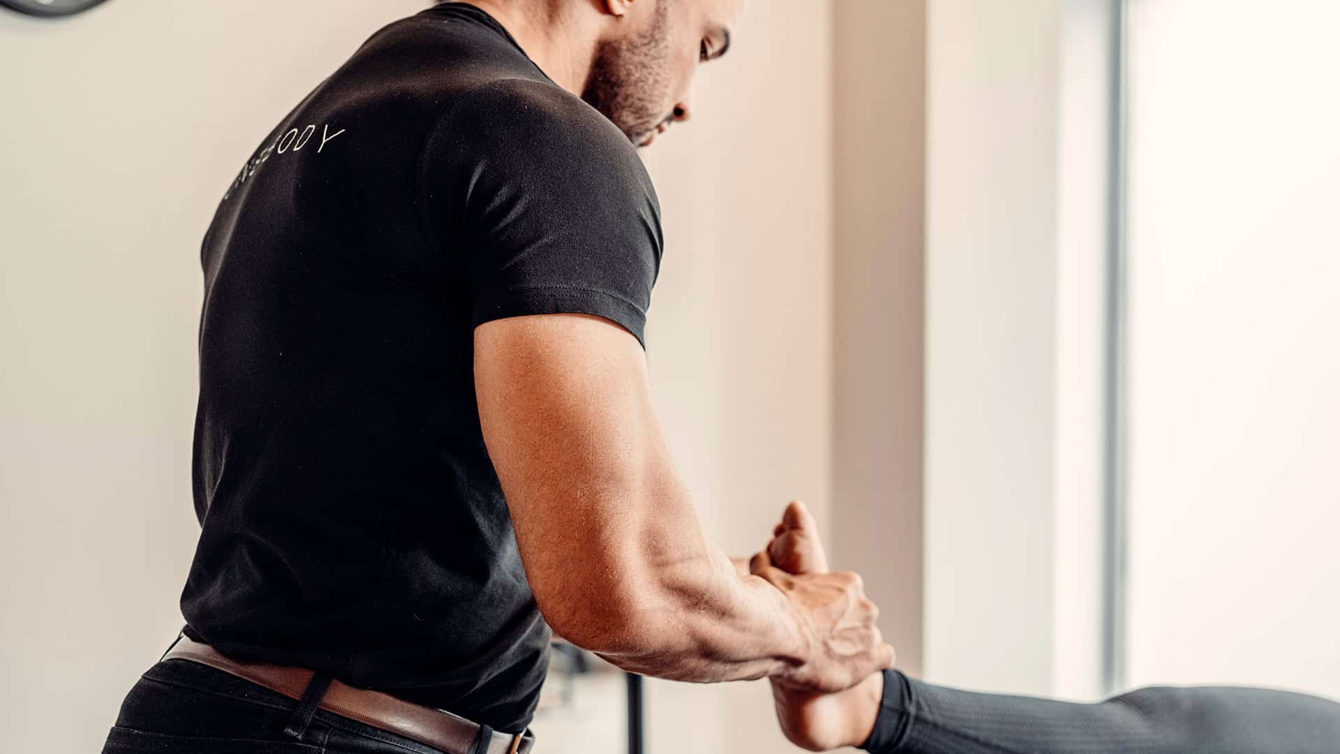 Professional physical therapist treats a patient's ankle