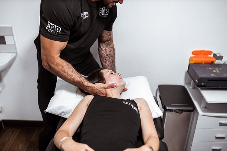 Man helping a woman with head pain treatment