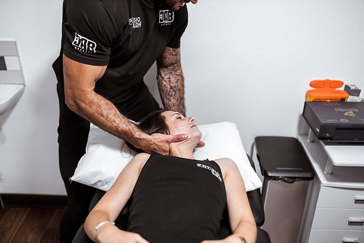 Physiotherapist performing neck therapy in London clinic