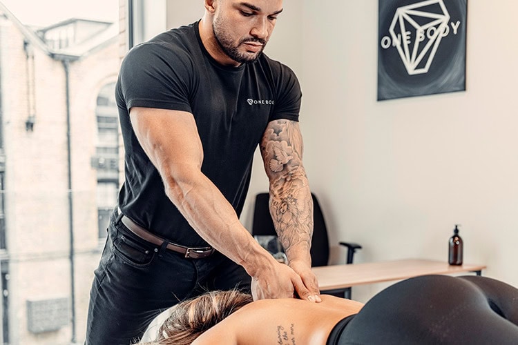 Therapist using deep tissue massage to relieve chronic pain