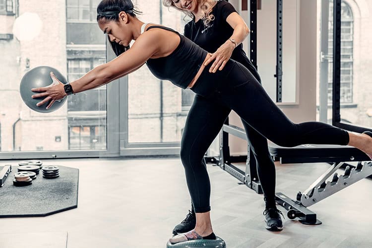 Professional female therapist assists a client with foot pain