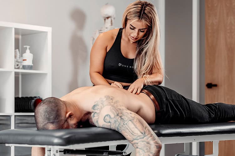 Sports physiotherapy session for a client with back pain.