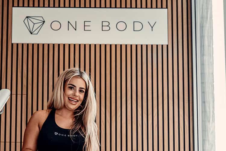 Smiling physiotherapist at One Body clinic – how to book a session in London