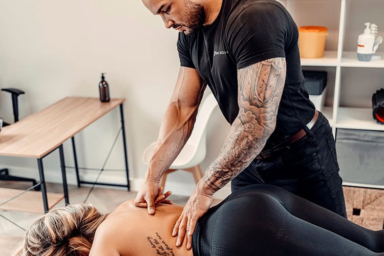 Physical therapist performing sports massage for injury prevention