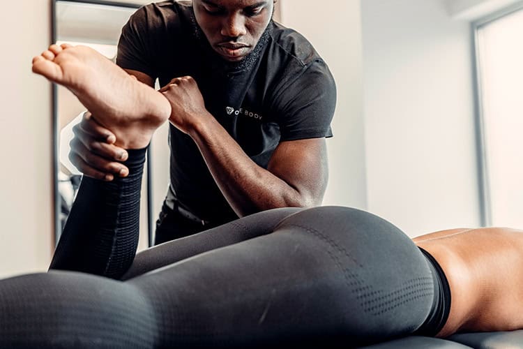 Man giving a sports massage to a patient