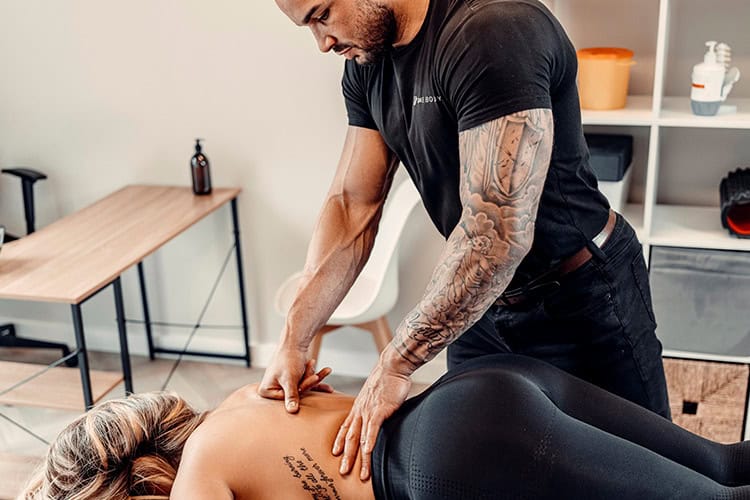 Physiotherapist performing deep tissue back massage in London clinic to relieve muscle tension and promote recovery