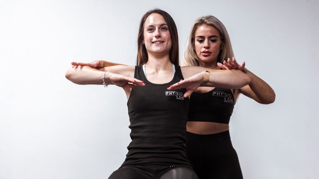 Physiotherapist conducting elbow pain rehabilitation with a patient at London clinic