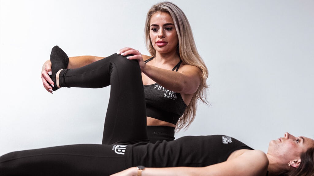 Physiotherapist conducting knee pain rehabilitation with a patient at London clinic