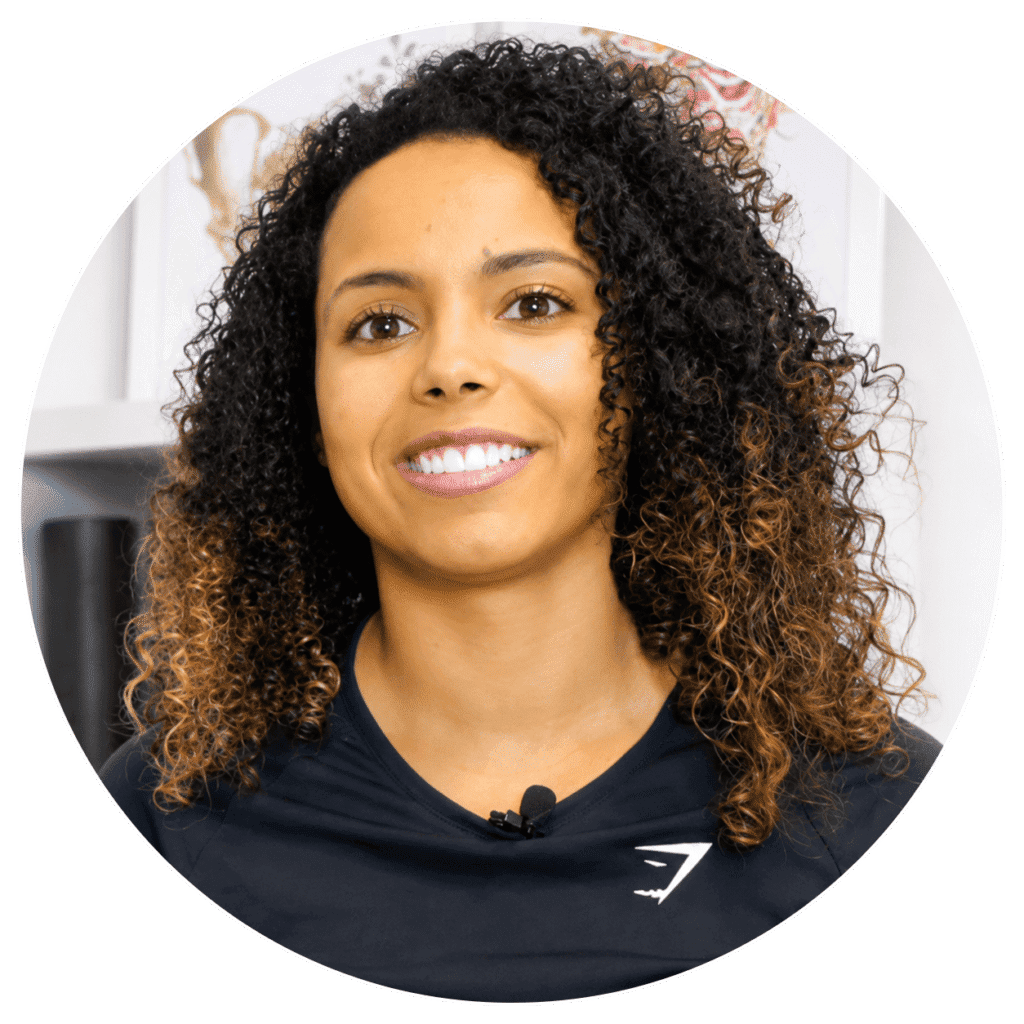 Female physiotherapist smiling in clinic setting at One Body LDN.